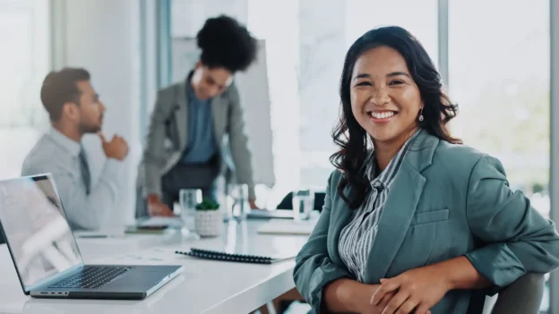 A woman smiling during a business meeting.