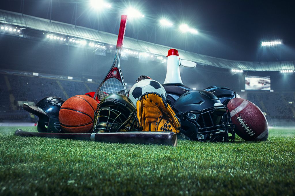 An assortment of athletic equipment on an illuminated field.