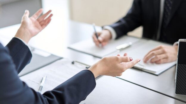 Two business professionals discuss details of a policy