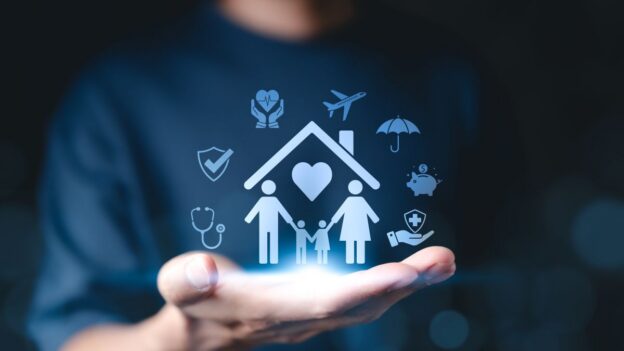 A man holds icons of insurance benefits that can obtain risk