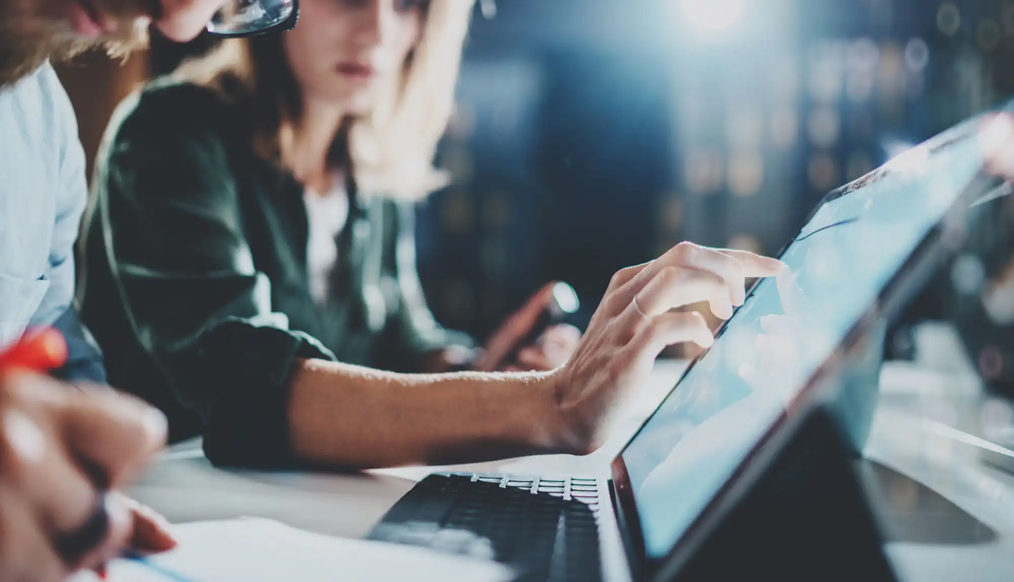 A woman reviewing some information on a laptop computer.