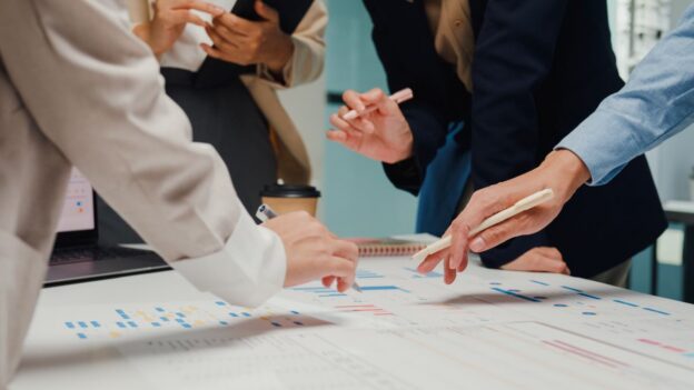 Team members discussing graphs and charts