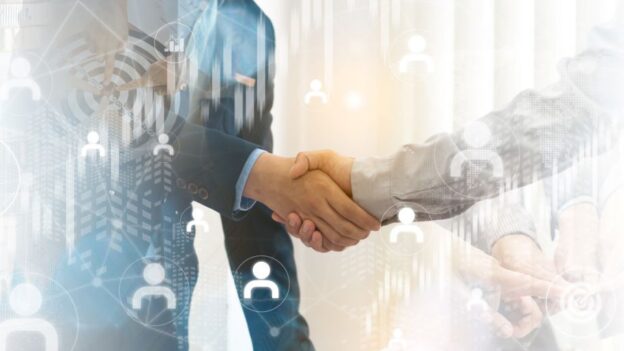 Two businessmen shake hands on an agreed partnership
