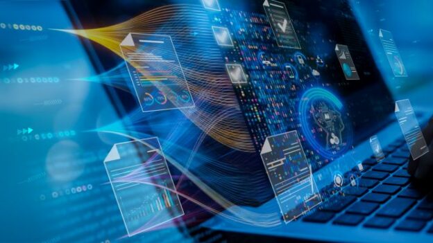 Multiple aspects of business technology coming out of a computer screen
