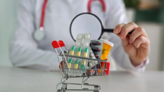 A small grocery cart filled with pharmacy prescriptions