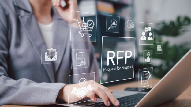 A girl sitting at a computer with multiple aspects of an RFP hovering outside the screen